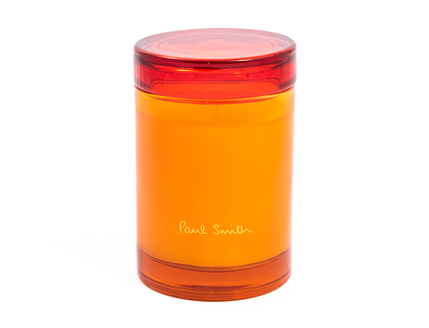 Die Duftkerze Bookworm in orangenem Glas mit rotem Deckel von Paul Smith